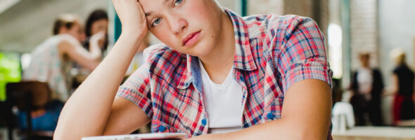 Exhausted student is sitting at the table