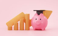 Piggy bank with black graduation hat and coins