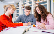 Students studying together in library