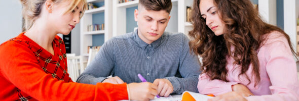 Students studying together in library