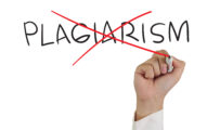 Hand crossing out the word "PLAGIARISM" with a red marker