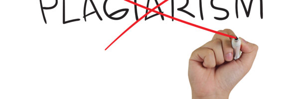 Hand crossing out the word "PLAGIARISM" with a red marker